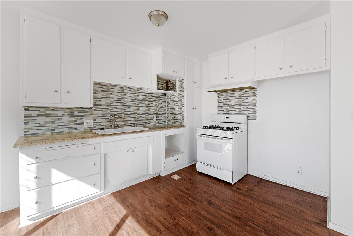 Before: Kitchen before renovation with older cabinets and appliances