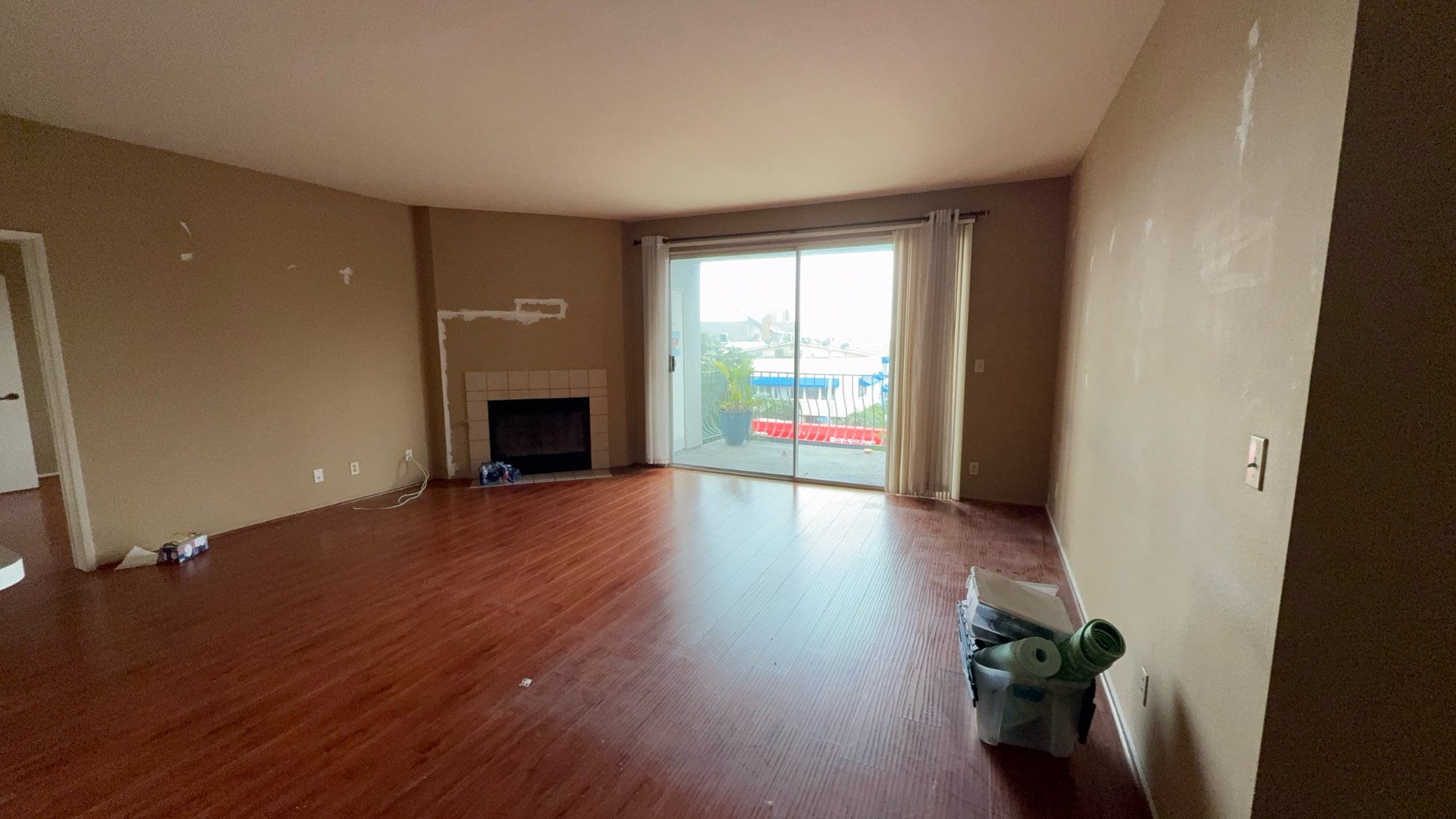 Before: Living room before renovation with worn walls and old flooring