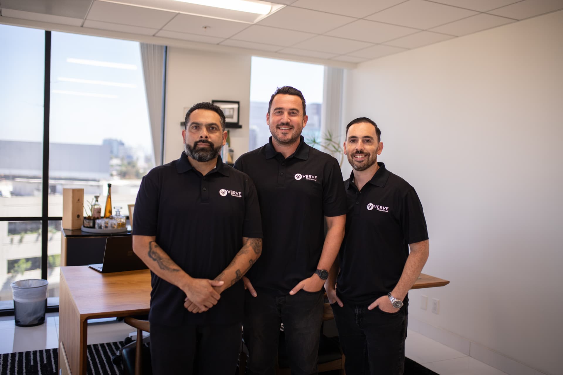 The VERVE Construction team — Tony Saucedo, Avi Kram and Edan Avital — in matching branded polos at their Los Angeles office