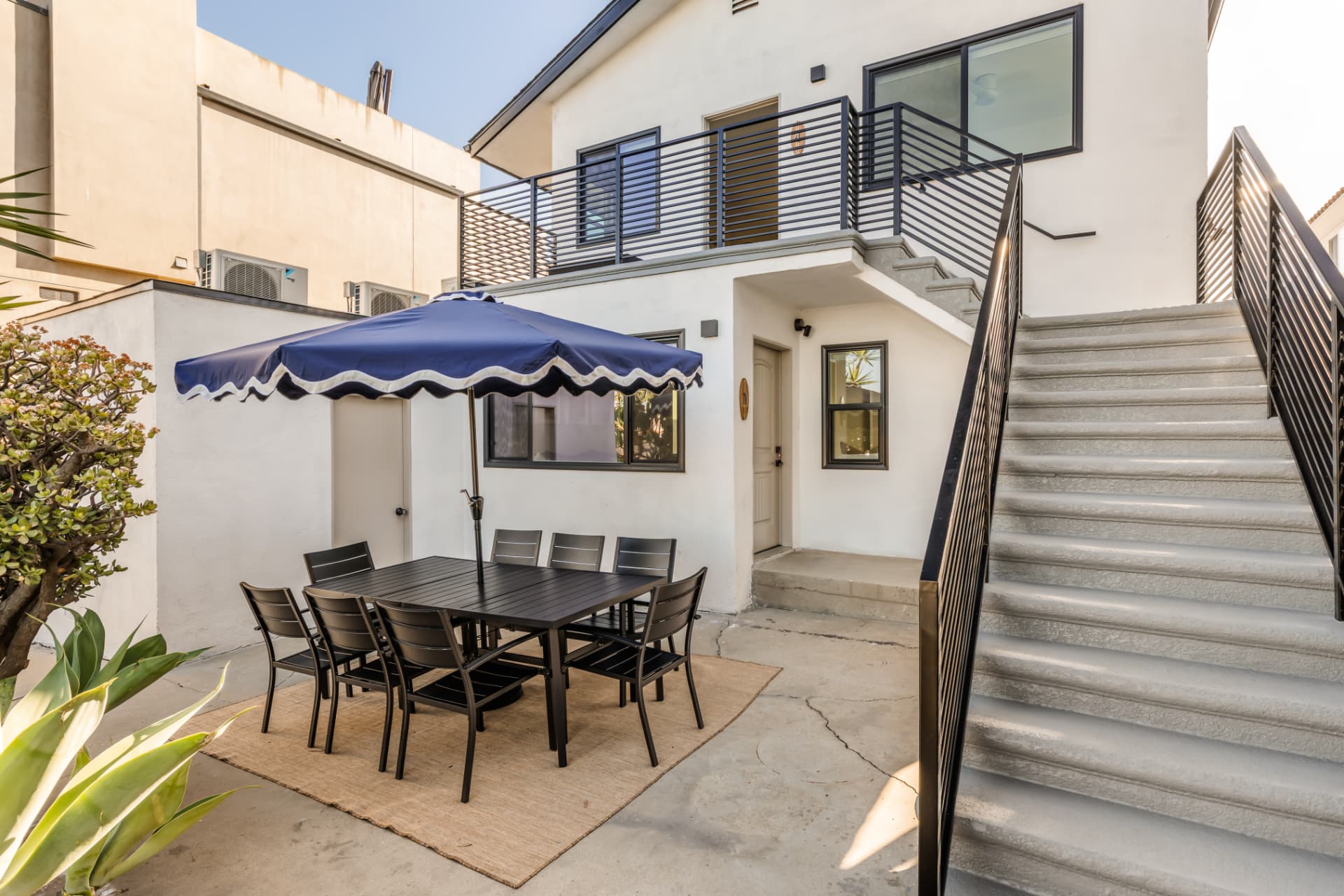 After: Renovated courtyard with new stairs, railings and outdoor dining area