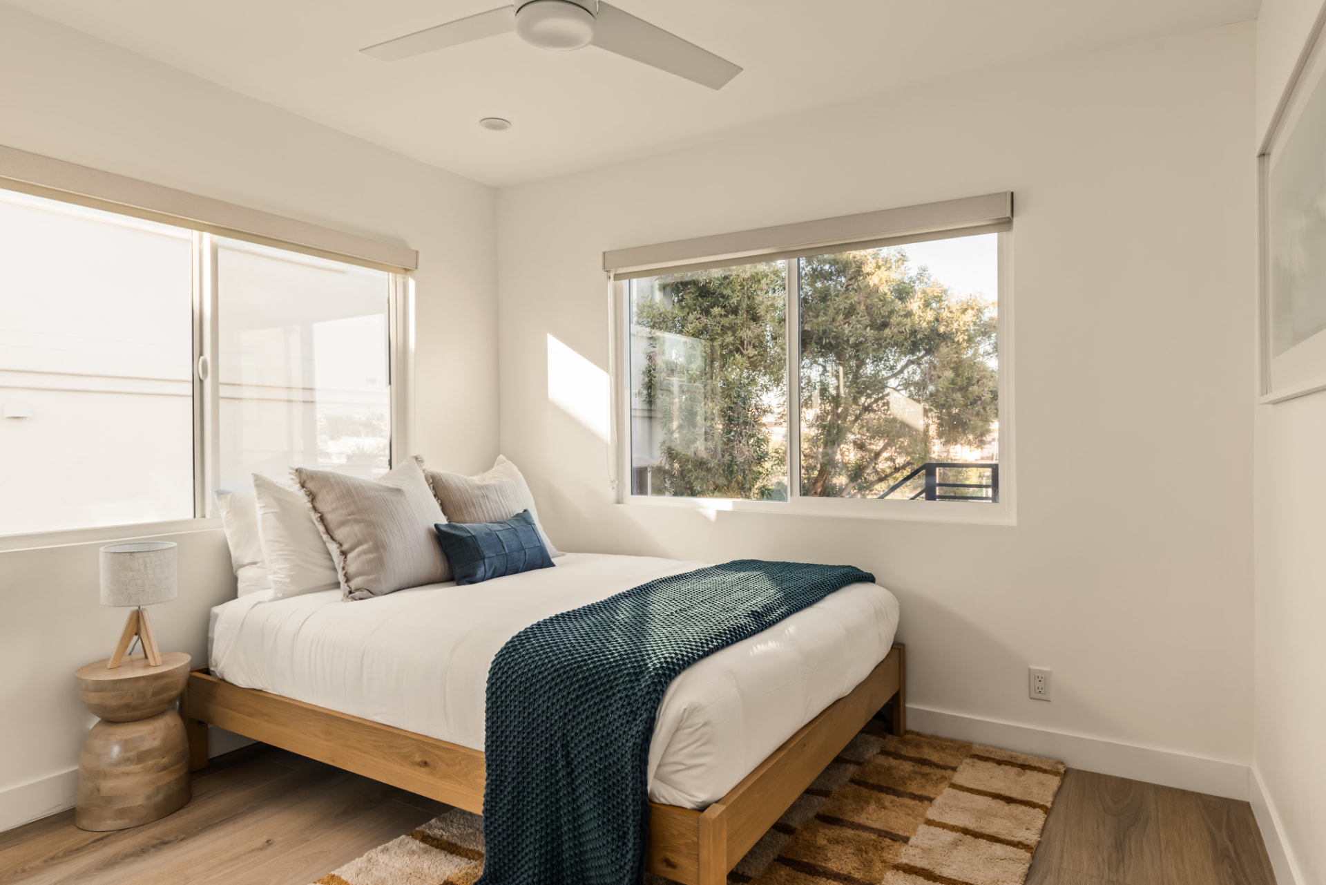 After: Renovated bedroom with new flooring, windows and staging
